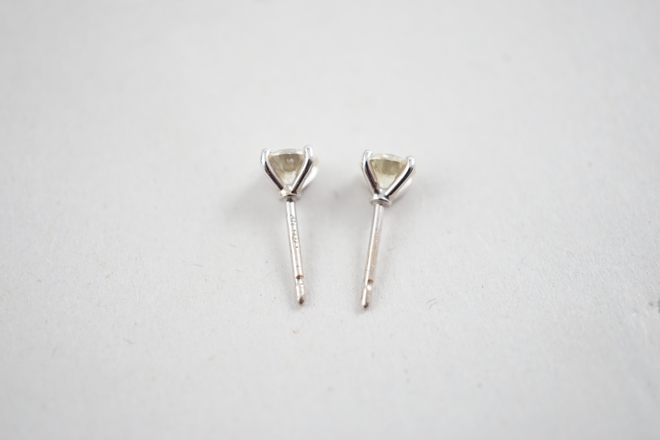 A pair of 18k white gold and solitaire diamond set ear studs